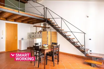 a dining room with a table and a staircase at Casa Meli dietro Piazza San Domenico by Wonderful Italy in Palermo