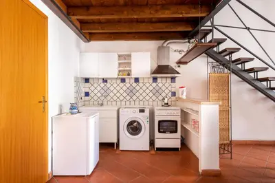 a laundry room with washing machines and a washer and dryer at Casa Meli dietro Piazza San Domenico by Wonderful Italy in Palermo