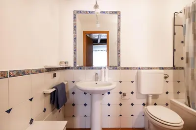 a bathroom with a toilet and a sink and a mirror at Casa Meli dietro Piazza San Domenico by Wonderful Italy in Palermo