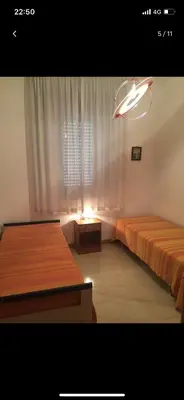 a bedroom with two beds and a window at Villa con piscina 