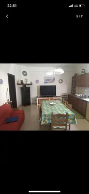 a living room with a table and a couch at Villa con piscina 