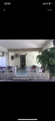 a picture of a building with a stone wall at Villa con piscina 