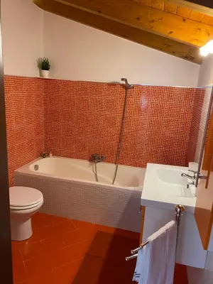 a bathroom with a tub and a toilet and a sink at HELIOS House in Palermo