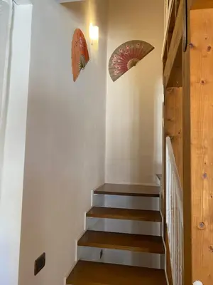 a staircase in a house with umbrellas on the wall at HELIOS House in Palermo