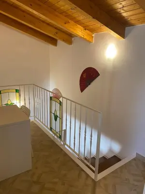 a room with a staircase with stained glass windows at HELIOS House in Palermo
