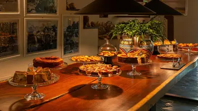 a buffet of pies and cakes on a wooden table at Magaggiari Hotel Resort in Cinisi