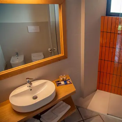 a bathroom with a sink and a mirror at Magaggiari Hotel Resort in Cinisi