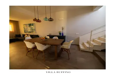a dining room with a table and chairs at Appartamento in Villa con idromassaggio in Balestrate