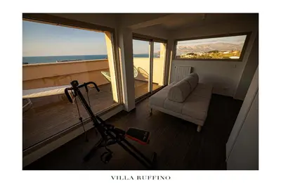a living room with a view of the ocean at Appartamento in Villa con idromassaggio in Balestrate