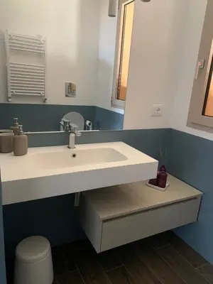 a bathroom with a white sink and a mirror at Appartamento in Villa con idromassaggio in Balestrate
