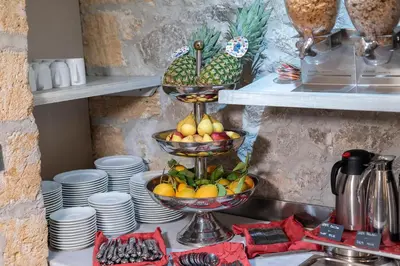 a counter with two baskets of fruit in a kitchen at Hotel Tonic in Palermo