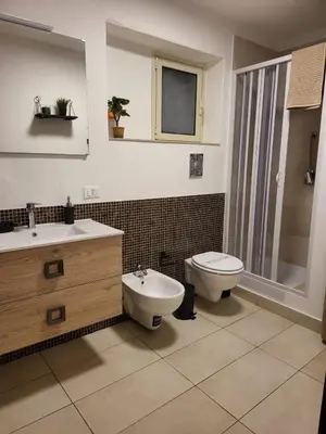 a bathroom with a sink and a mirror at Giovenchi’s Apartment in Palermo