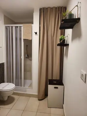 a bathroom with a toilet and a sink at Giovenchi’s Apartment in Palermo