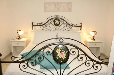 a bedroom with a black and white bed with two lamps at Desy Appartamenti in San Vito lo Capo