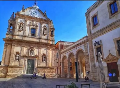 an old building with a clock on top of it at Casa Costantino in Alcamo