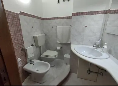 a bathroom with a toilet and a sink at Casa Costantino in Alcamo