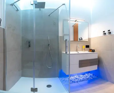 a bathroom with a shower and a toilet and a sink at Nuar suite&spa in Palermo
