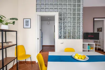 a kitchen with yellow and blue tiles on the wall at Sedie Volanti Apartment with Jacuzzi in Palermo
