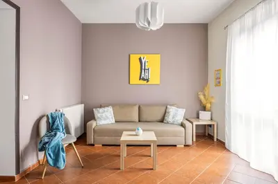 a living room with a table and a couch at Sedie Volanti Apartment with Jacuzzi in Palermo