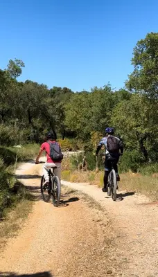 two people riding bikes on a dirt road at Elima's Mood in Scopello