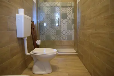 a bathroom with a toilet and a shower at Elima's Mood in Scopello