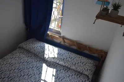 a bed in a room with a window at Elima's Mood in Scopello