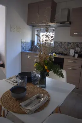 a kitchen with a table with utensils on it at Elima's Mood in Scopello