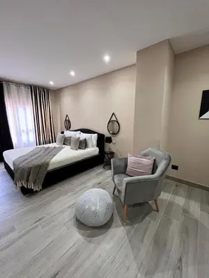 a bedroom with a bed and a chair at CB Rooms in Termini Imerese