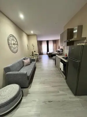 a living room with a couch and a kitchen at CB Rooms in Termini Imerese