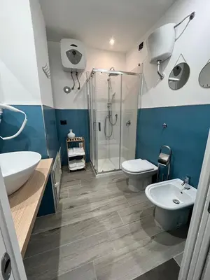 a bathroom with a shower and a toilet and a sink at CB Rooms in Termini Imerese