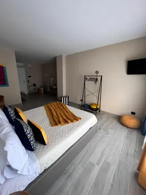 a bedroom with a bed with a blanket on it at CB Rooms in Termini Imerese