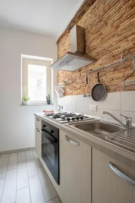 a kitchen with a sink and a stove at Casa dei Quattro Canti B&B in Palermo