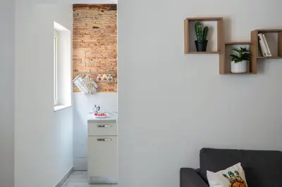 a living room with a kitchen and a couch at Casa dei Quattro Canti B&B in Palermo