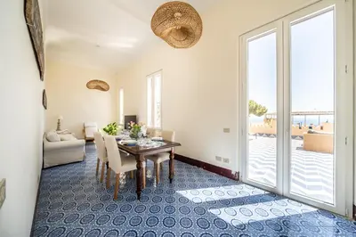 a dining room with a table and a view of the ocean at I Merli sull'acqua - Suite in Palermo