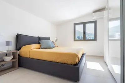 a bedroom with a bed and a window at Villa Costamante con piscina privata in Balata di Baida