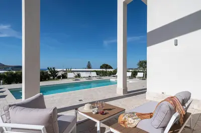 a patio with a table and chairs and a pool at Villa Costamante con piscina privata in Balata di Baida
