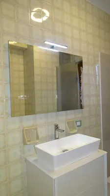 a bathroom with a white sink and a mirror at Il Gabbiano al Capo in Palermo