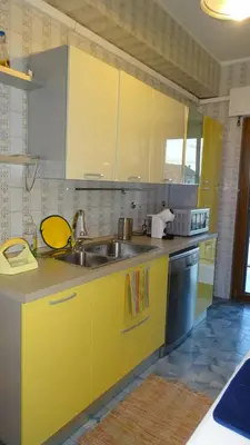 a kitchen with yellow cabinets and a sink at Il Gabbiano al Capo in Palermo