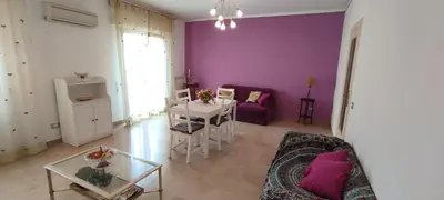 a living room with purple walls and a couch and a table at Il Gabbiano al Capo in Palermo