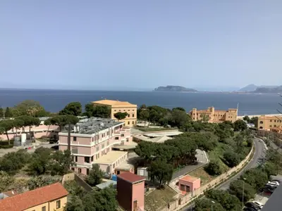 a view of a city with the ocean in the background at Leo's Home in Palermo