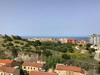 a town on a hill with the ocean in the background at Leo's Home in Palermo