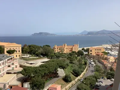 a view of a street in a town next to the water at Leo's Home in Palermo