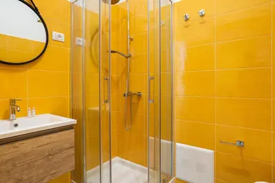 a bathroom with a glass shower and a sink at Le Cinque Stanze Palermo Room&Breakfast in Palermo