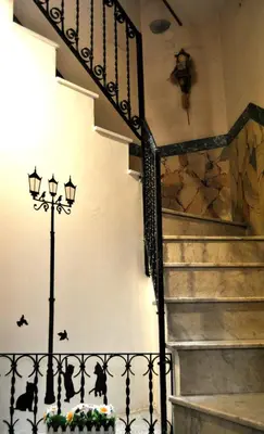 a stairway with a wrought iron railing and a staircase at In Piazza casavacanze in Palermo