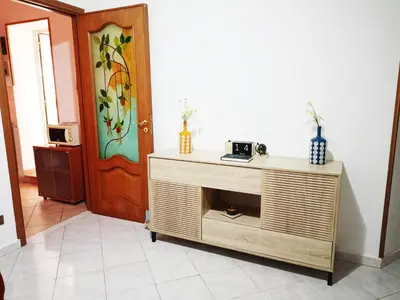 a room with a wooden cabinet and a door at In Piazza casavacanze in Palermo