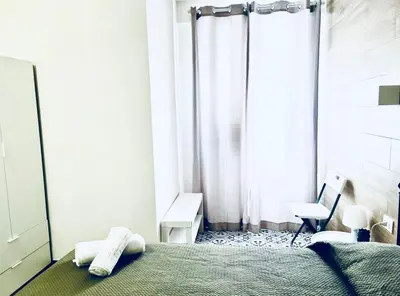 a bedroom with a bed with a lamp and a socket at Casa sulla spiaggia in Castellammare del Golfo