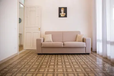 a living room with a couch and a door at Ciatu mè in Alcamo