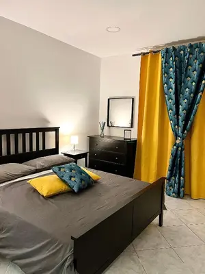 a bedroom with a bed and a dresser and a mirror at Mondello front beach in Palermo
