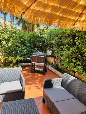 a patio with two couches and a table at Mondello front beach in Palermo
