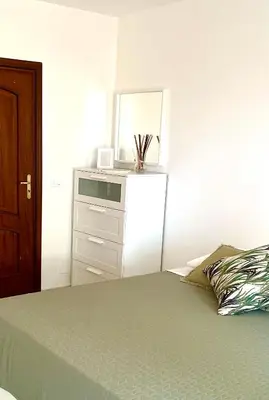 a bedroom with a bed with a dresser and a mirror at Mondello front beach in Palermo